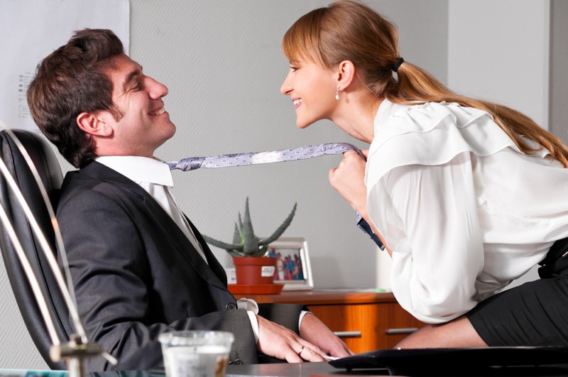 Businesswoman & man flirting