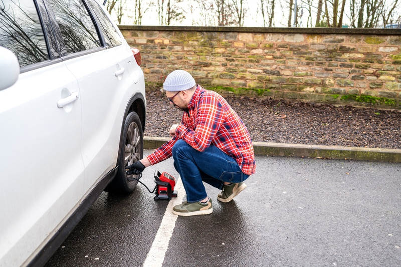 Man Checking Car Tyre